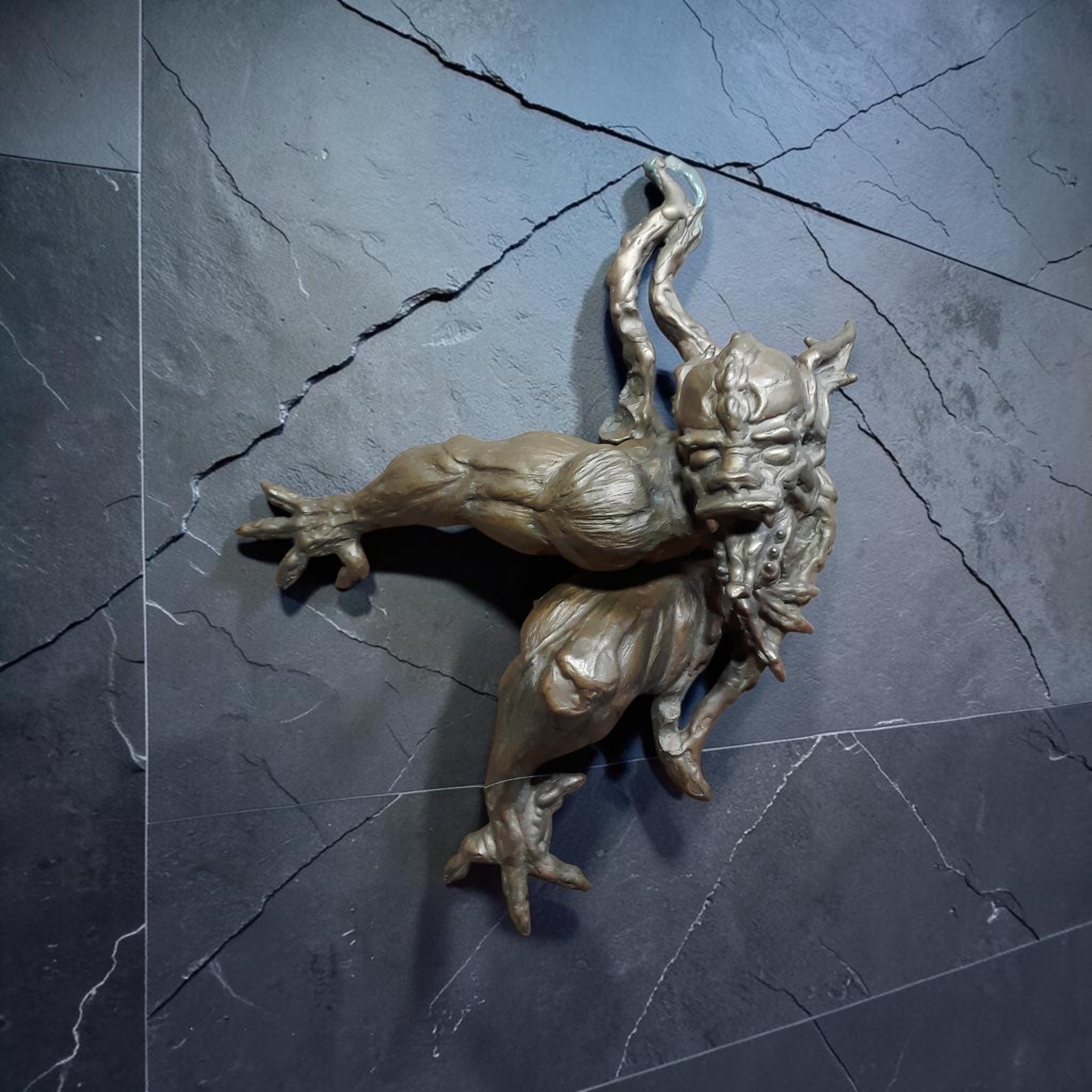 Tarn, a horned creature emerging from a wall with clawed feet and an open mouth.